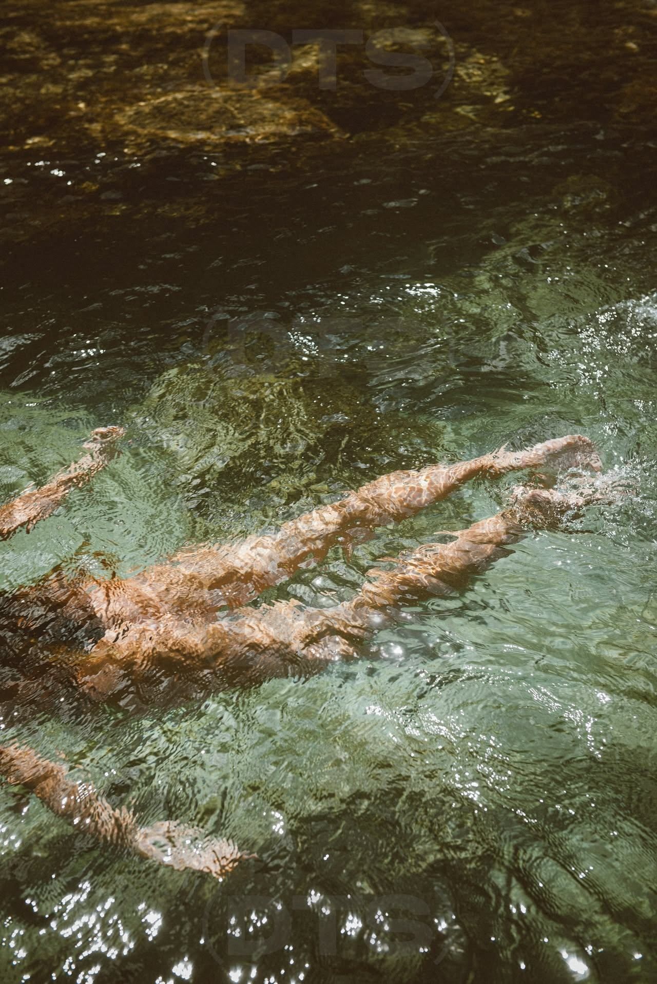 Swimmers in green water